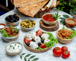 outdoor lunch with salads, olives and bread